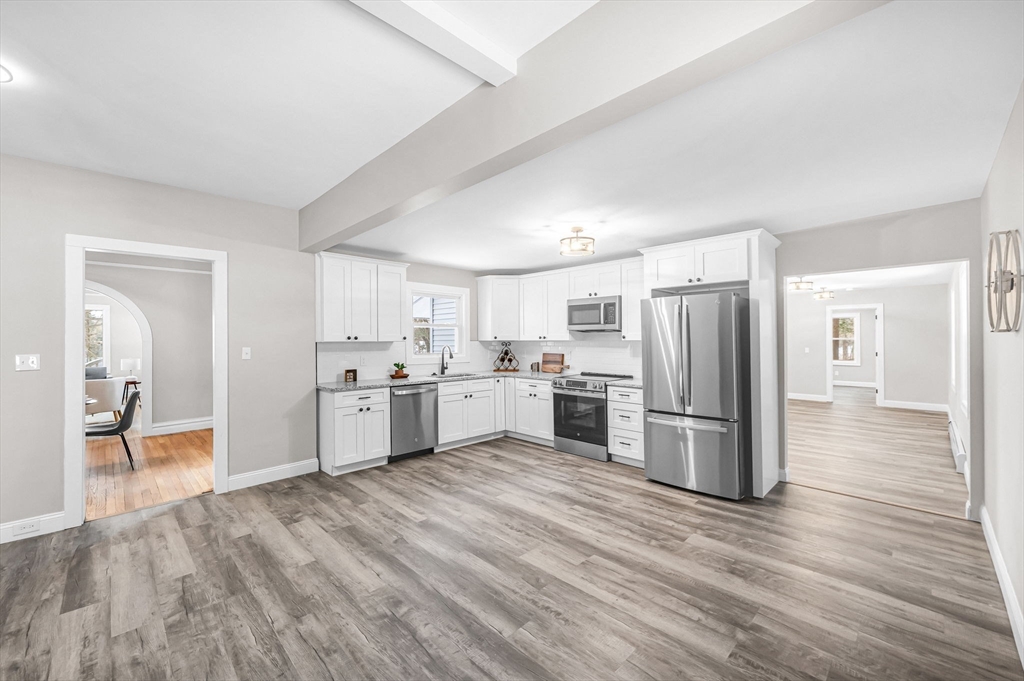 270 South Main Street Orange, MA 01364 - Photo 20 of 41 a kitchen with white cabinets and stainless steel appliances