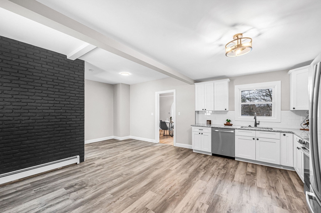 270 South Main Street Orange, MA 01364 - Photo 21 of 41 a large kitchen with stainless steel appliances granite countertop a stove a sink dishwasher and a refrigerator with white cabinets