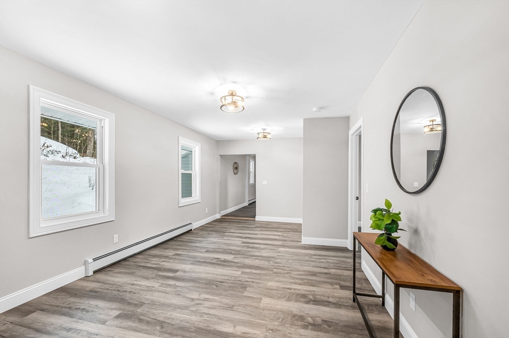 270 South Main Street Orange, MA 01364 - Photo 24 of 41 a hallway with wooden floor and a chandelier