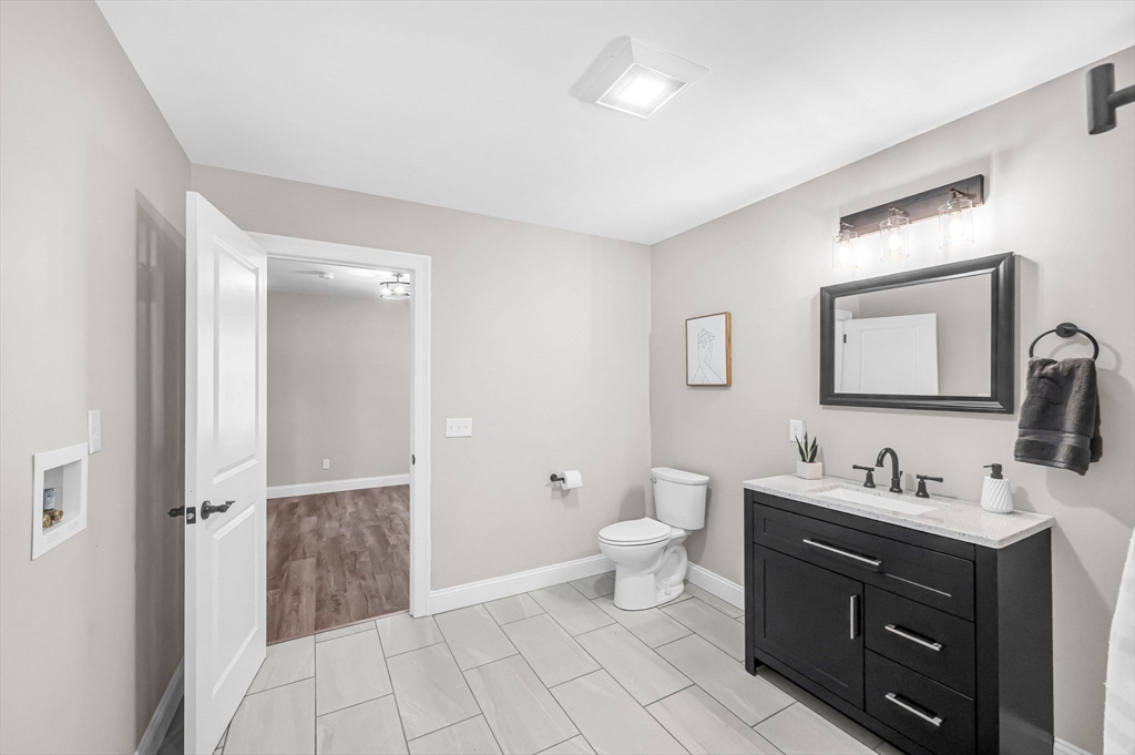 270 South Main Street Orange, MA 01364 - Photo 32 of 41 a bathroom with a toilet sink double vanity and mirror