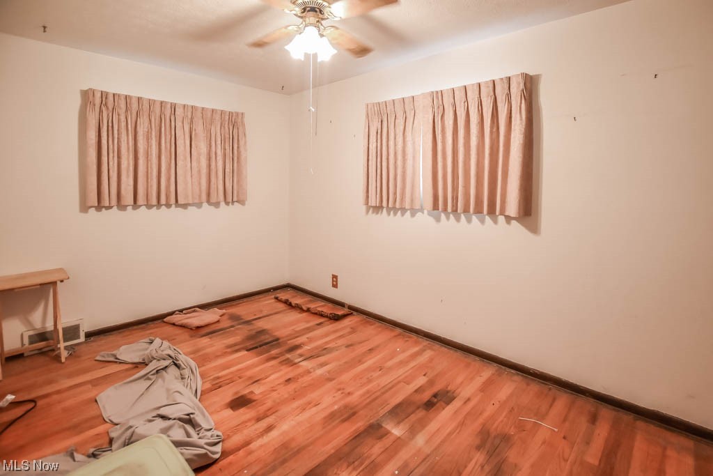 29947 Regent Road Wickliffe, OH 44092 - Photo 10 of 16 Hardwood floored empty room with ceiling fan