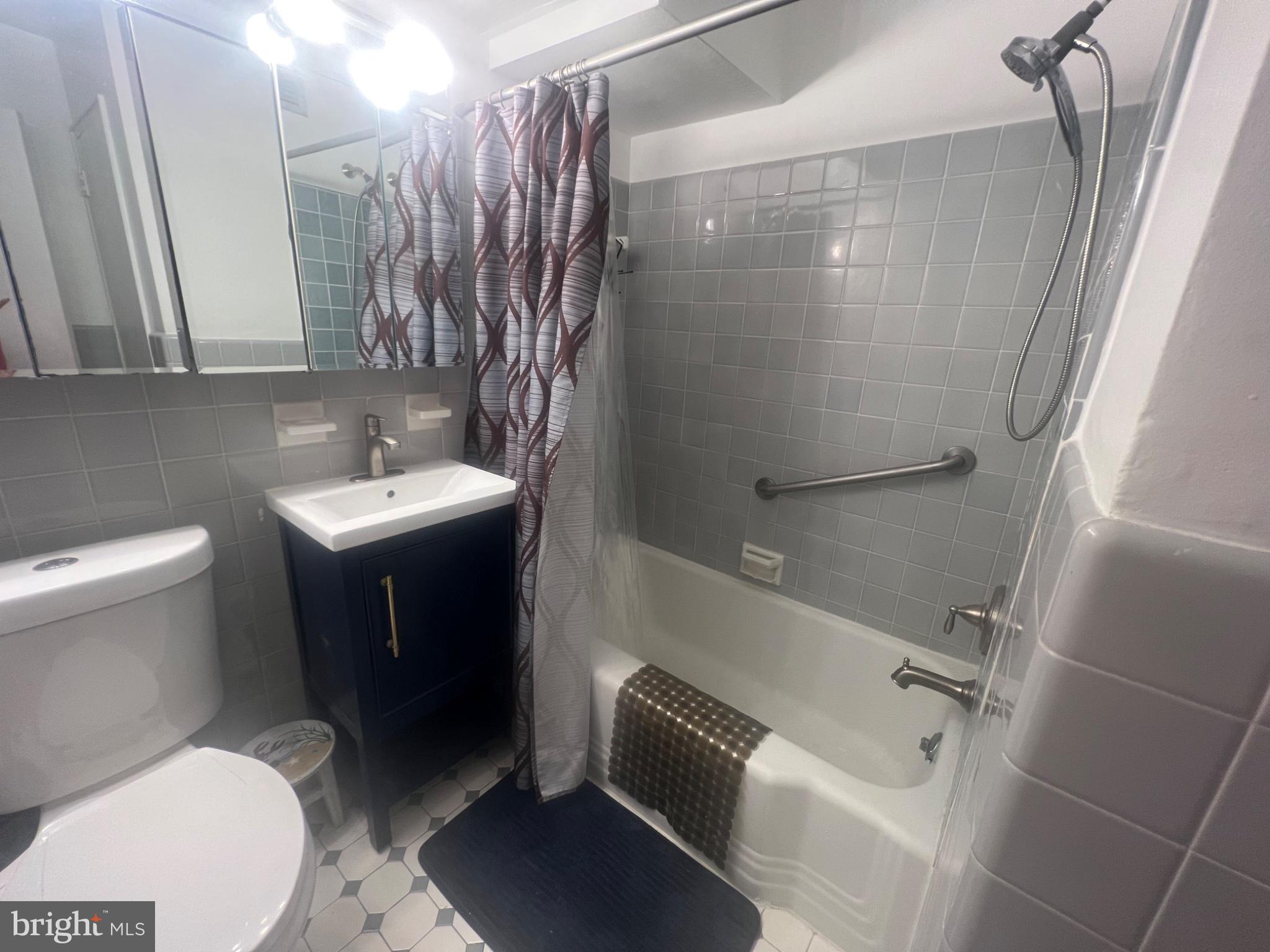101 South Raleigh Avenue Atlantic City, NJ 08401 - Photo 18 of 24 a bathroom with a sink a toilet and shower