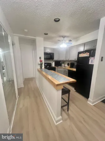a large kitchen with a table and chairs