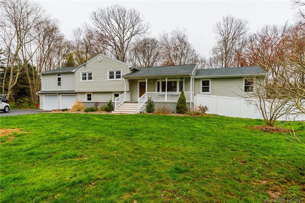 161 Flat Meadow Road Guilford, CT 06437 - Photo 1 of 1 a front view of house with yard and green space