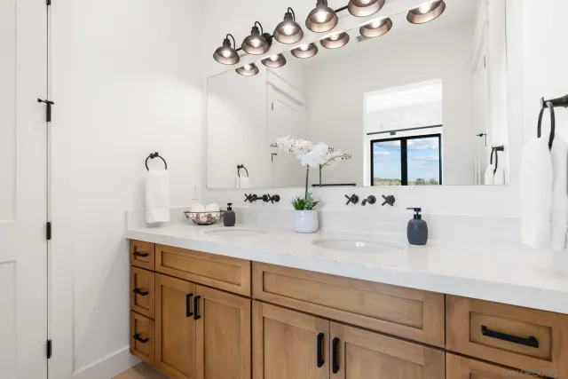 a bathroom with a sink vanity and mirror