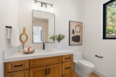 a bathroom with a toilet sink and mirror