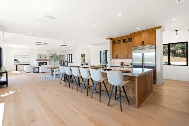 a large kitchen with a table and chairs