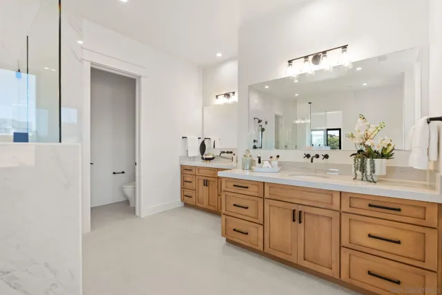 a spacious bathroom with a granite countertop sink mirror and a