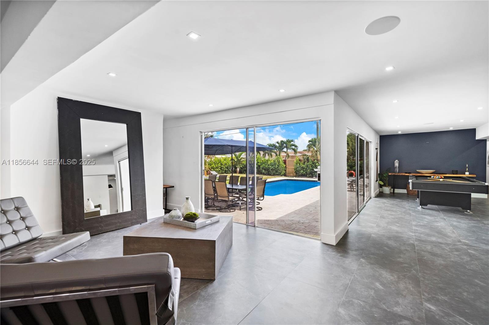 4322 Polk Street Hollywood, FL 33021 - Photo 13 of 43 a living room with furniture and a floor to ceiling window