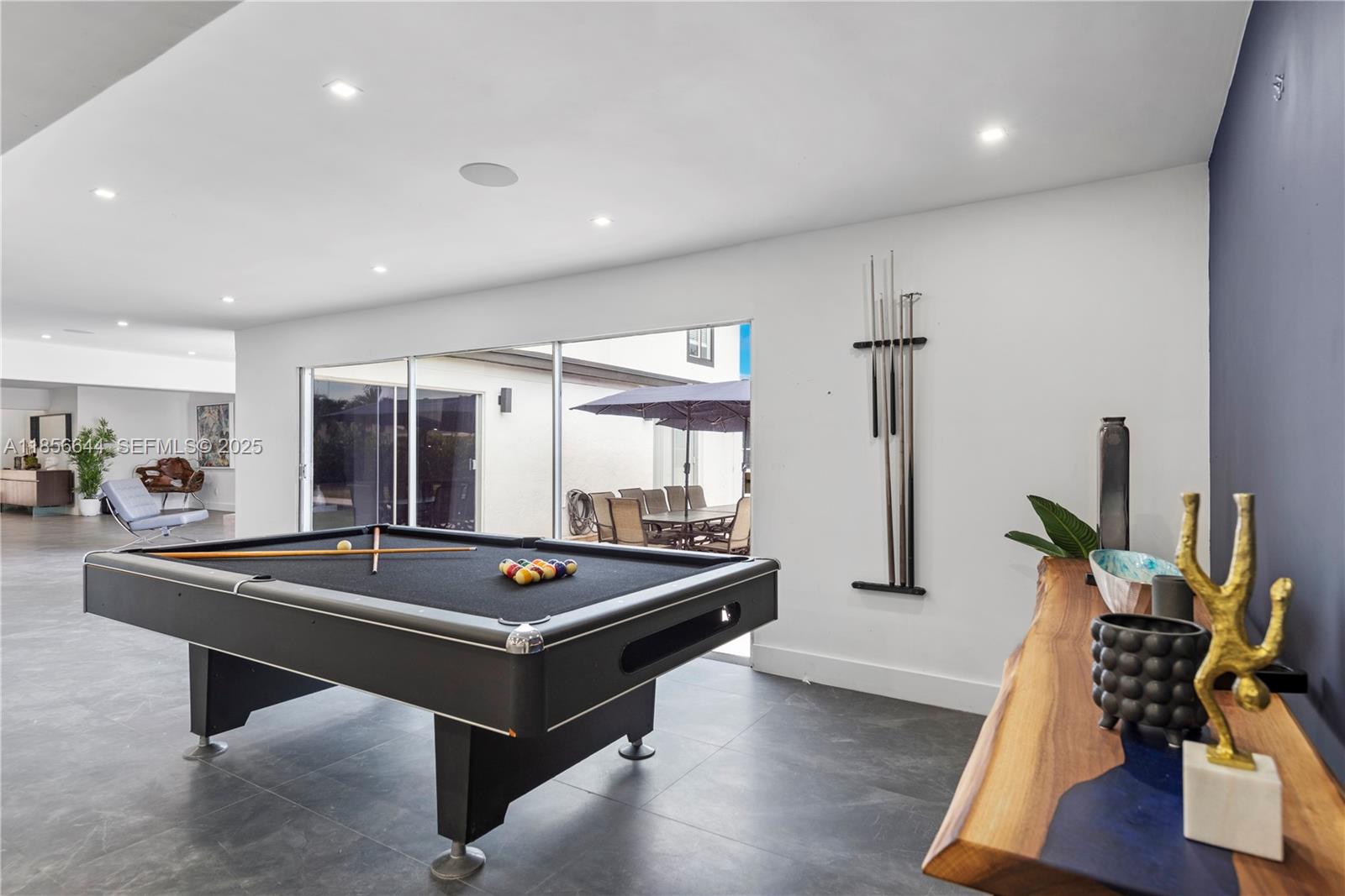 4322 Polk Street Hollywood, FL 33021 - Photo 16 of 43 a room with wooden floor pool table and windows