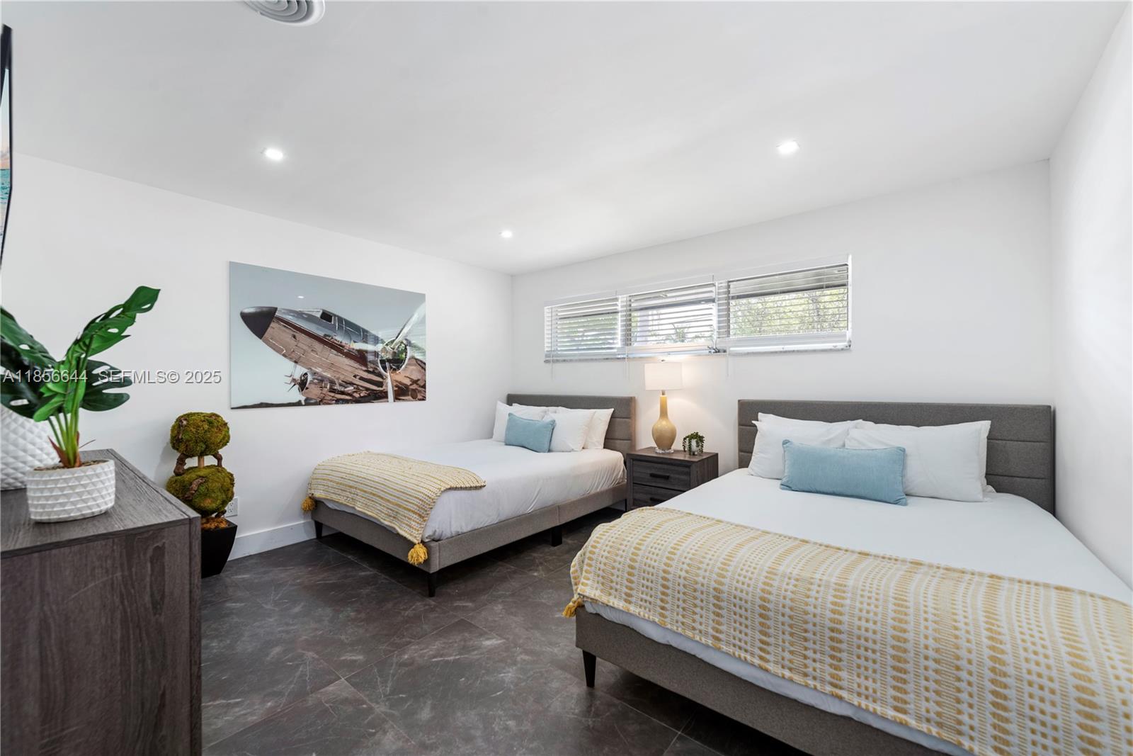 4322 Polk Street Hollywood, FL 33021 - Photo 21 of 43 a bedroom with two beds and painting on the wall