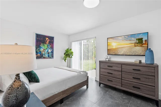 a bedroom with a large bed and a large window