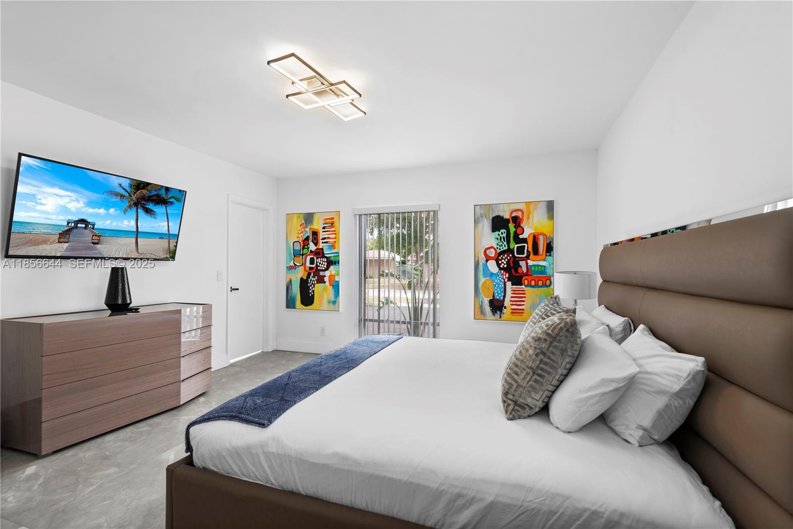 4322 Polk Street Hollywood, FL 33021 - Photo 28 of 43 a bedroom with a bed and a couch