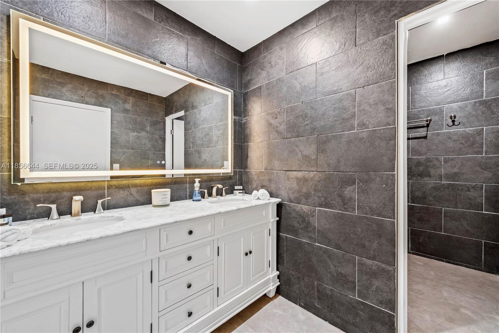 4322 Polk Street Hollywood, FL 33021 - Photo 29 of 43 a bathroom with a double vanity sink and a mirror