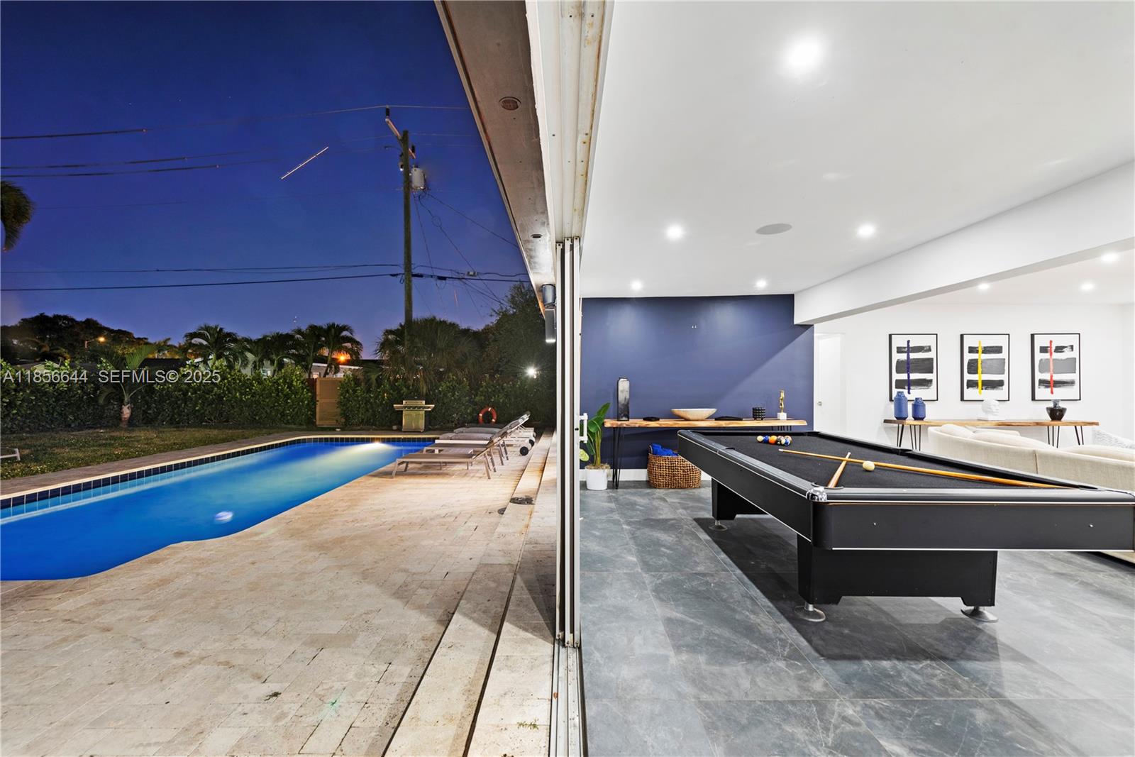 4322 Polk Street Hollywood, FL 33021 - Photo 38 of 43 a view of a swimming pool with a lounge chairs