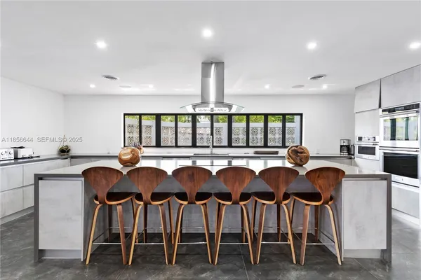 a large kitchen with lots of counter space and windows