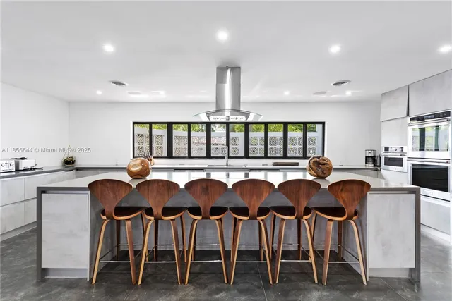 a large kitchen with lots of counter space and windows
