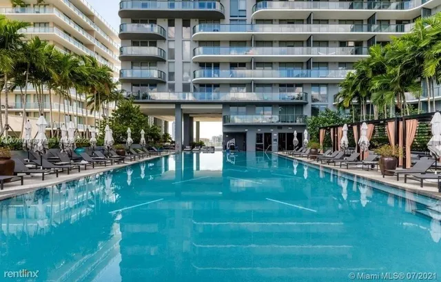 a view of a swimming pool with a outdoor seating