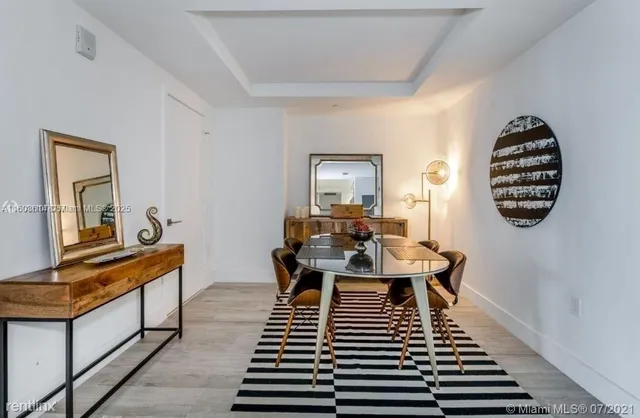 a dining room with furniture a rug and wooden floor