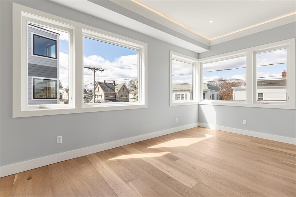 308 Newton Street, Unit 1F Waltham, MA 02453 - Photo 23 of 23 a view of an empty room with wooden floor and a window