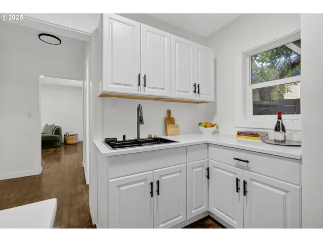 a kitchen with cabinets and window