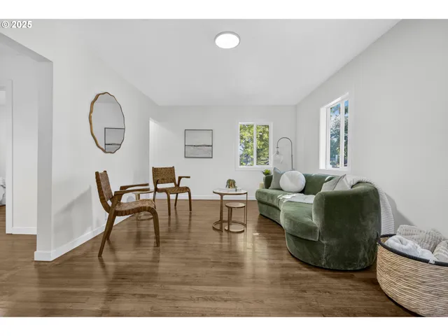 a living room with furniture wooden floor and a window