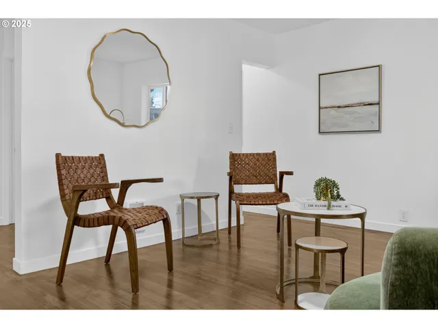 a dining room with furniture and a mirror