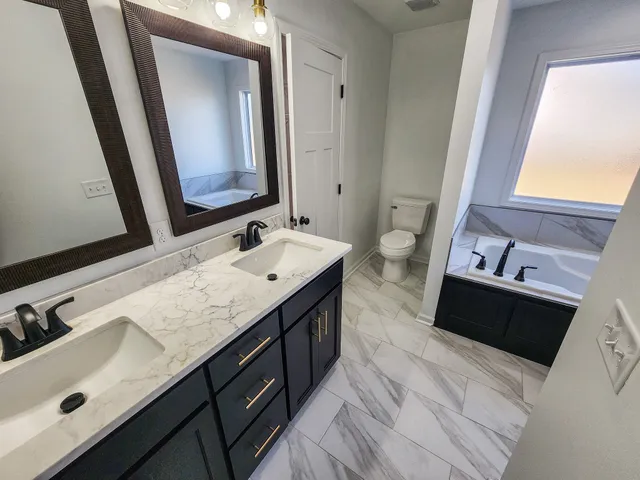 a spacious bathroom with a double vanity sink and mirror