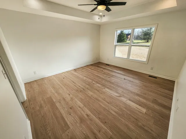 wooden floor in an empty room with a window