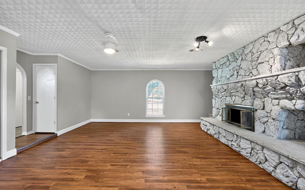 220 Short Street Burleson, TX 76028 - Photo 10 of 36 a view of an empty room with a fireplace and a window