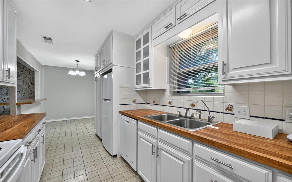 220 Short Street Burleson, TX 76028 - Photo 19 of 36 a kitchen with a sink and cabinets