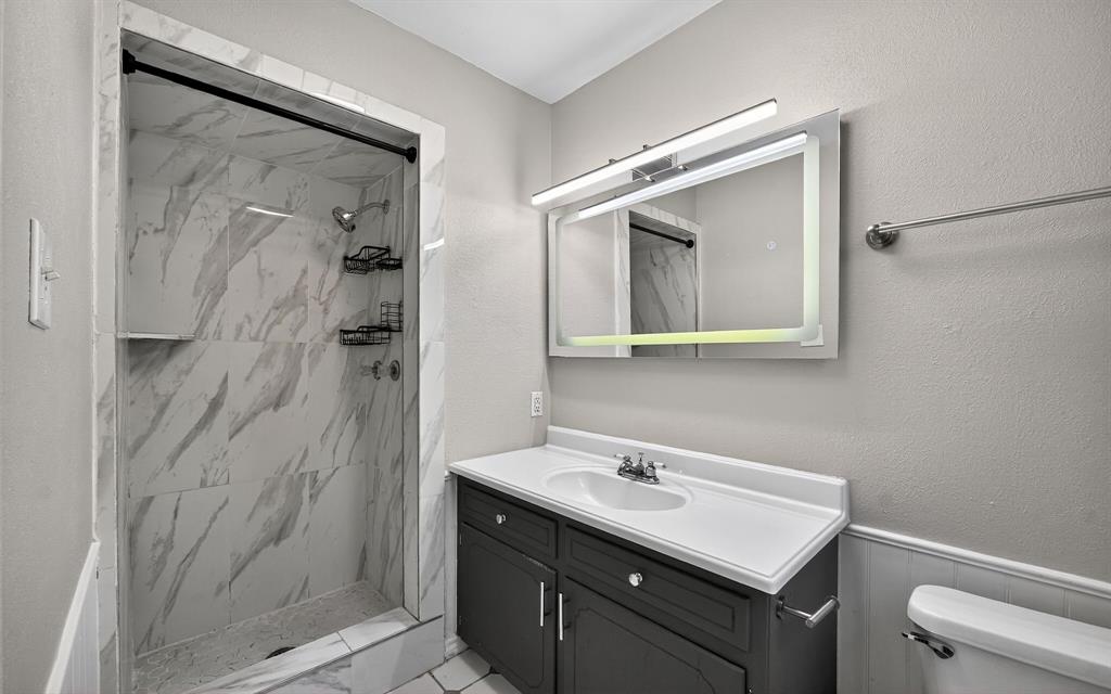 220 Short Street Burleson, TX 76028 - Photo 24 of 36 a bathroom with a sink vanity and a mirror