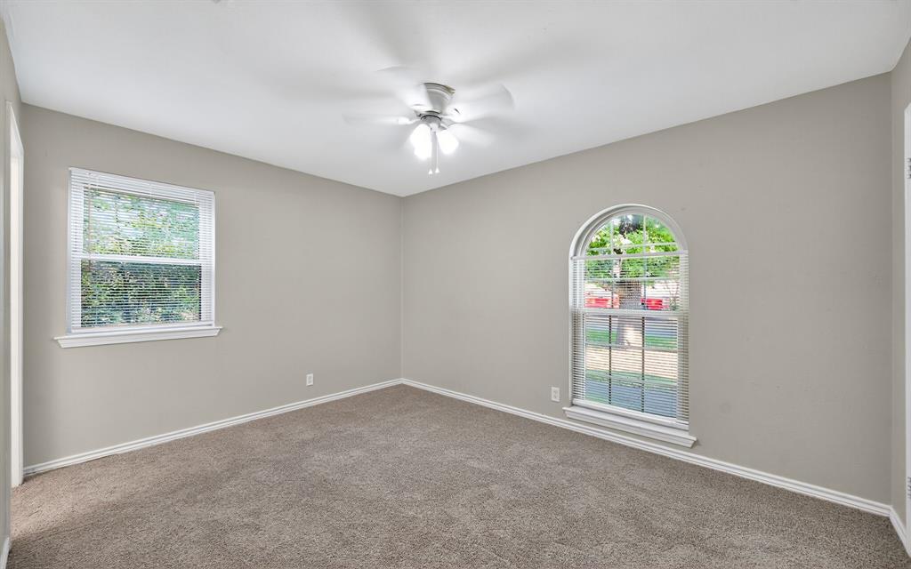 220 Short Street Burleson, TX 76028 - Photo 27 of 36 an empty room with windows and chandelier fan