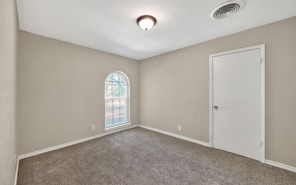 220 Short Street Burleson, TX 76028 - Photo 31 of 36 an empty room with windows and closet