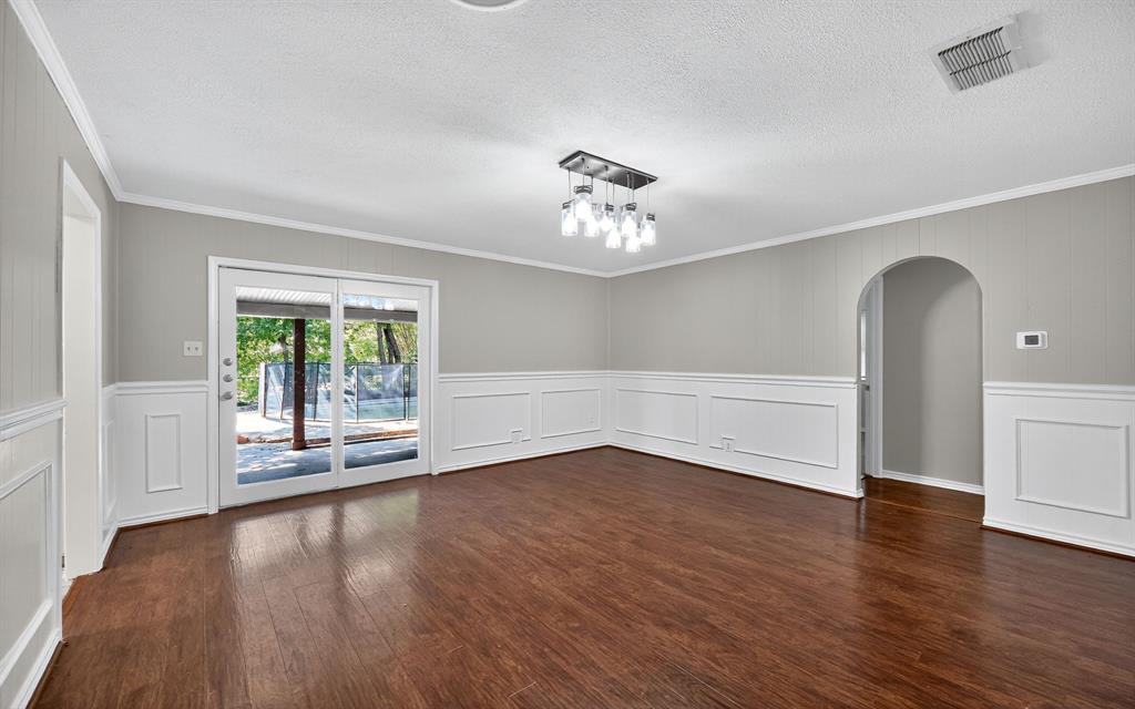 220 Short Street Burleson, TX 76028 - Photo 5 of 36 a view of an empty room with a window and wooden floor