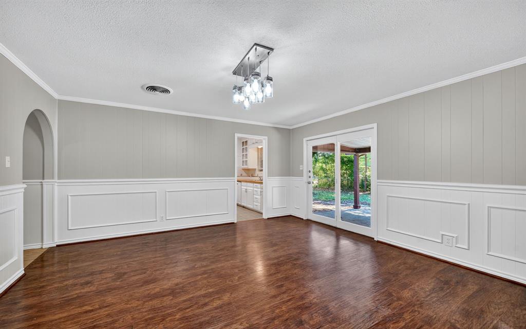 220 Short Street Burleson, TX 76028 - Photo 6 of 36 a view of an empty room with wooden floor and a window
