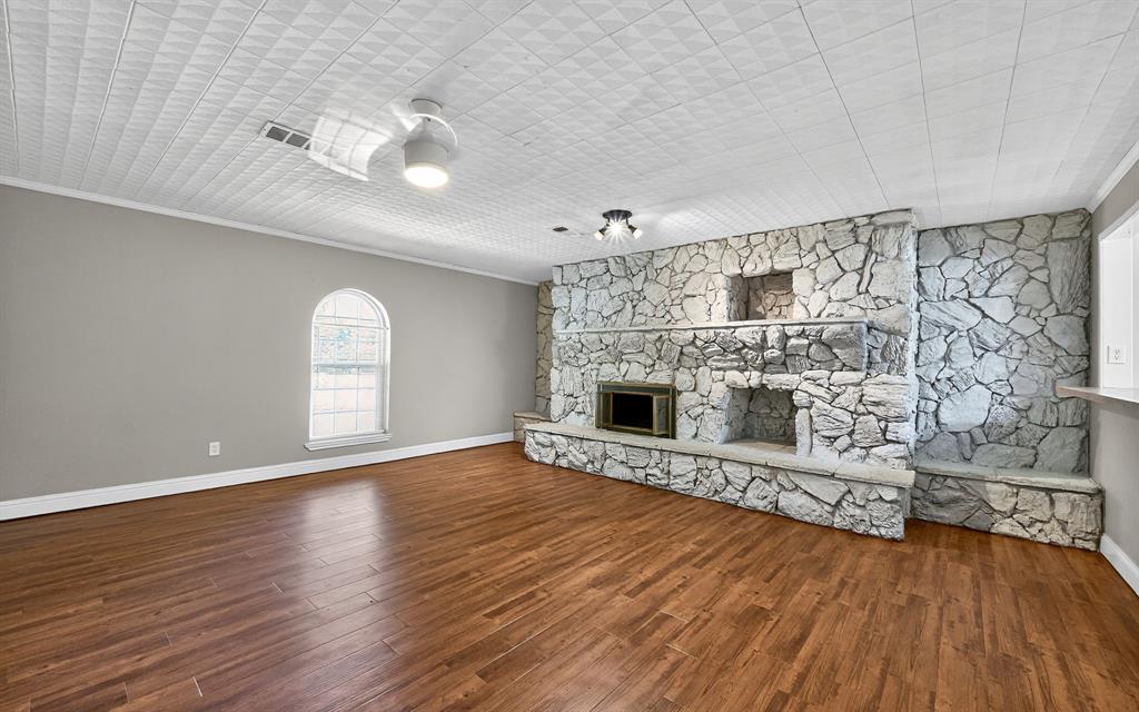 220 Short Street Burleson, TX 76028 - Photo 7 of 36 a view of empty room with wooden floor and fireplace