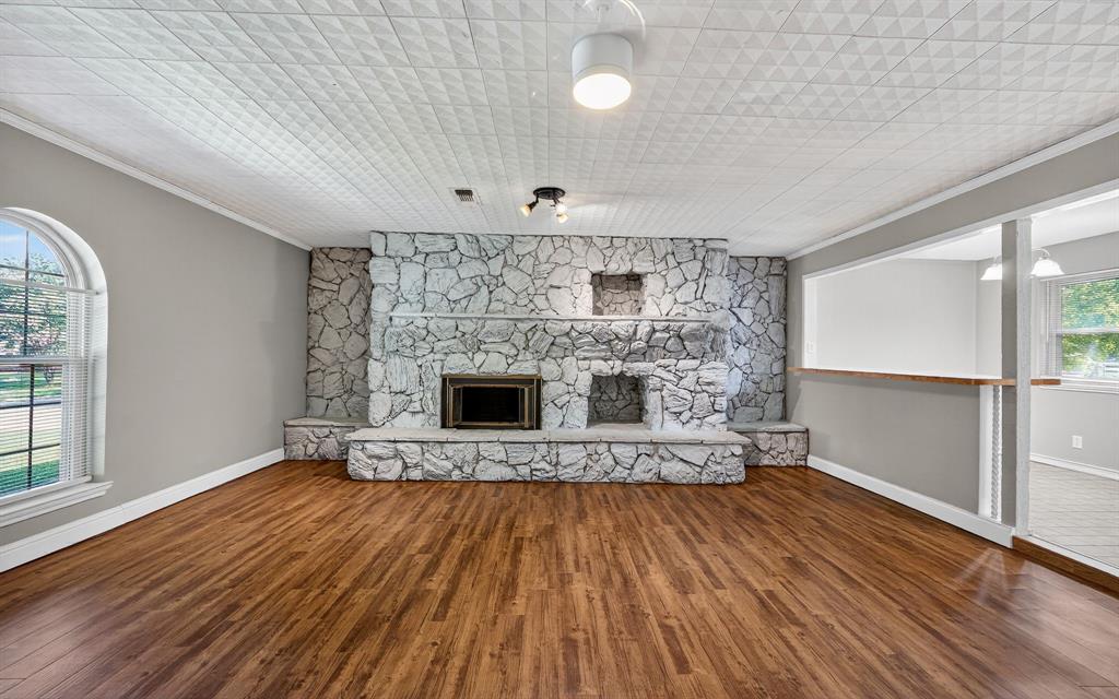 220 Short Street Burleson, TX 76028 - Photo 9 of 36 a view of empty room with wooden floor and fireplace