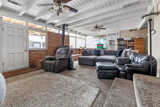 a living room with furniture ceiling fan and a rug