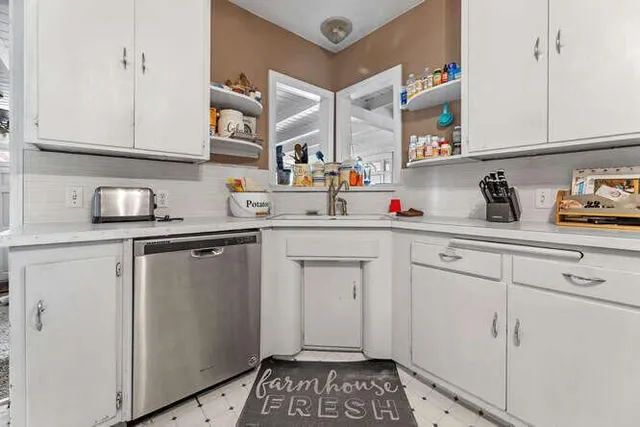 a kitchen with cabinets a sink and appliances