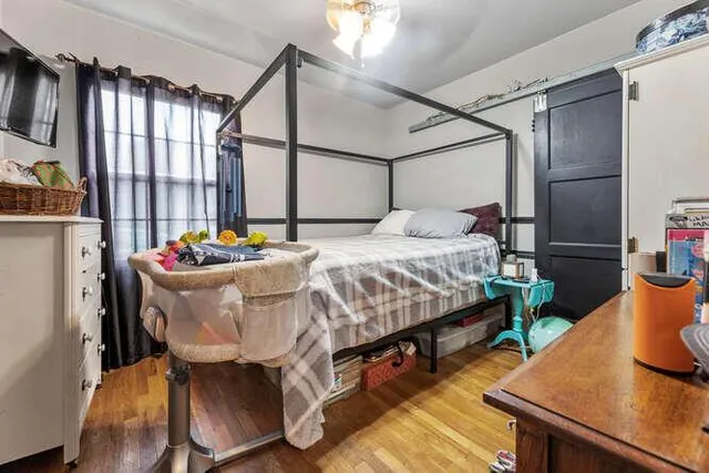 a bedroom with a bed and large windows