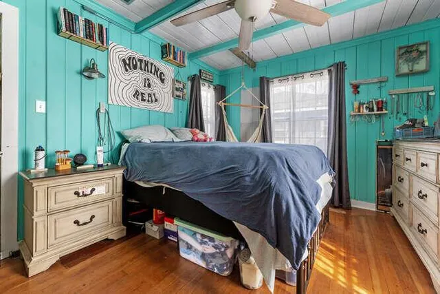 a bedroom with a bed and a dresser