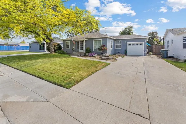 a front view of house with yard and green space
