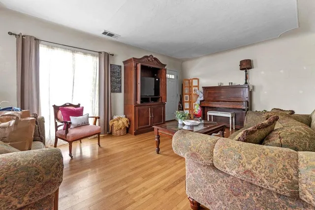a living room with furniture a fireplace and a large window
