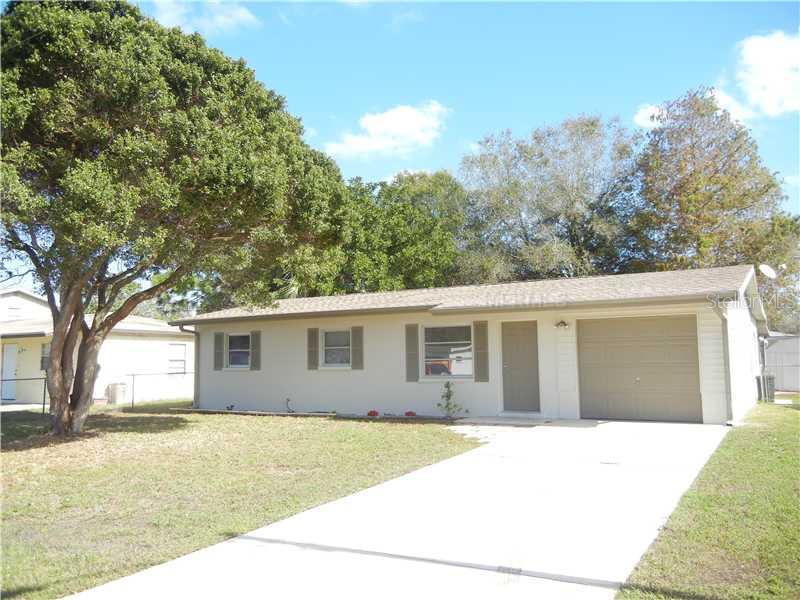 1036 Lillian Street Venice, FL 34285 - Photo 1 of 1 a backyard of a house with large trees