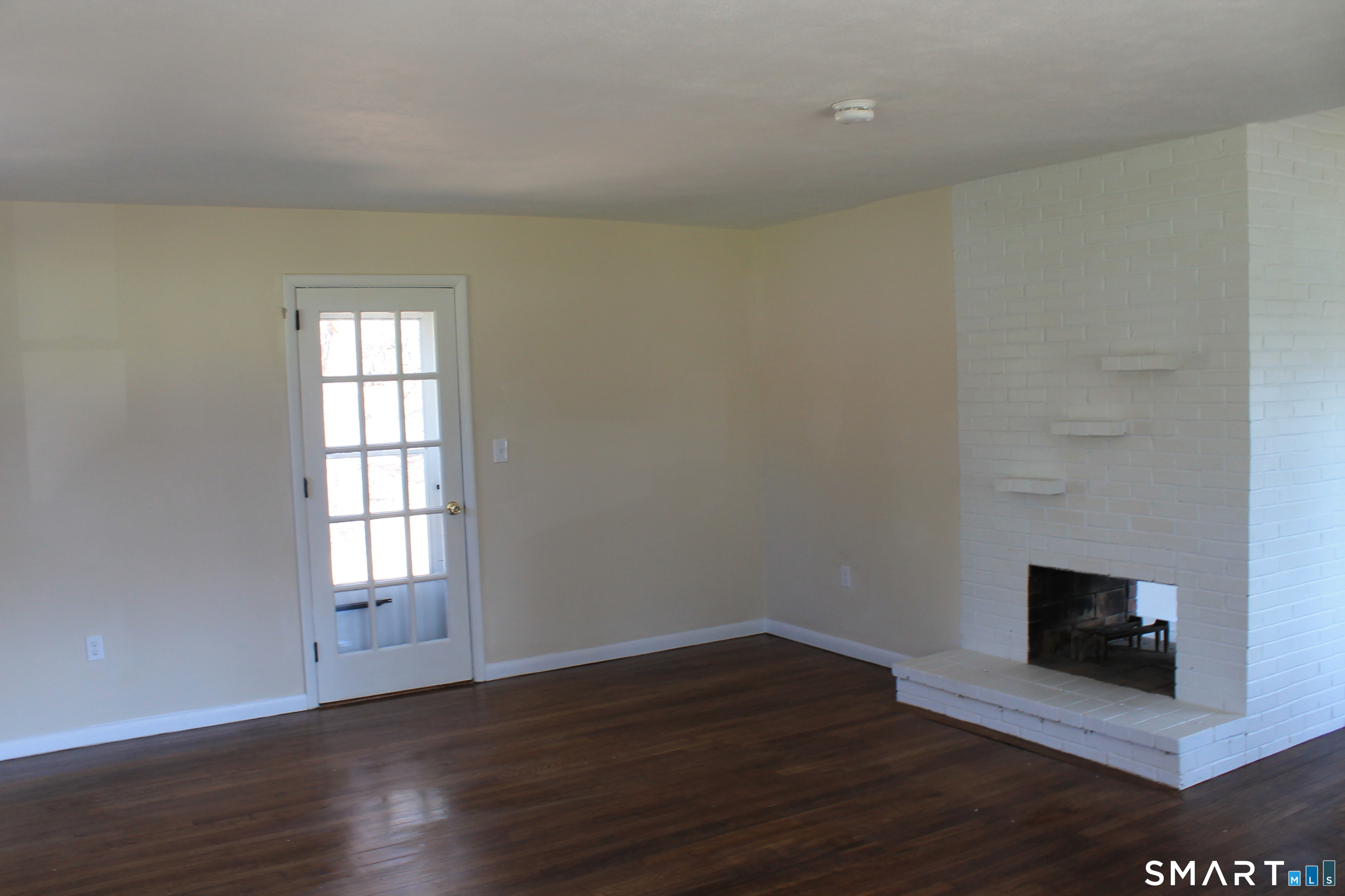 134 Sunset Street Windsor Locks, CT 06096 - Photo 16 of 23 a view of empty room with wooden floor and fireplace