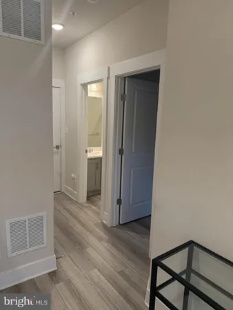 an empty room with wooden floor and a window