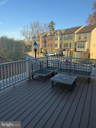 a view of a house with a wooden bench
