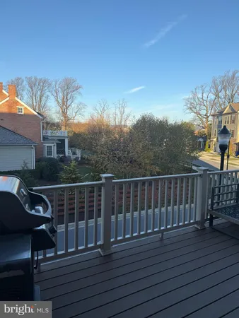 a view of a roof deck with wooden floor and fence