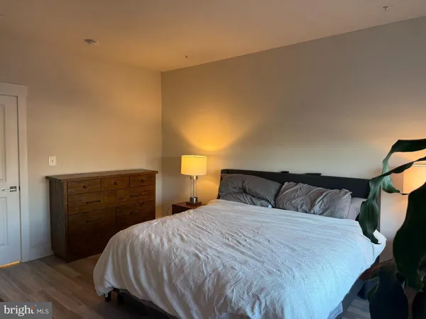 a bedroom with a bed and a dresser